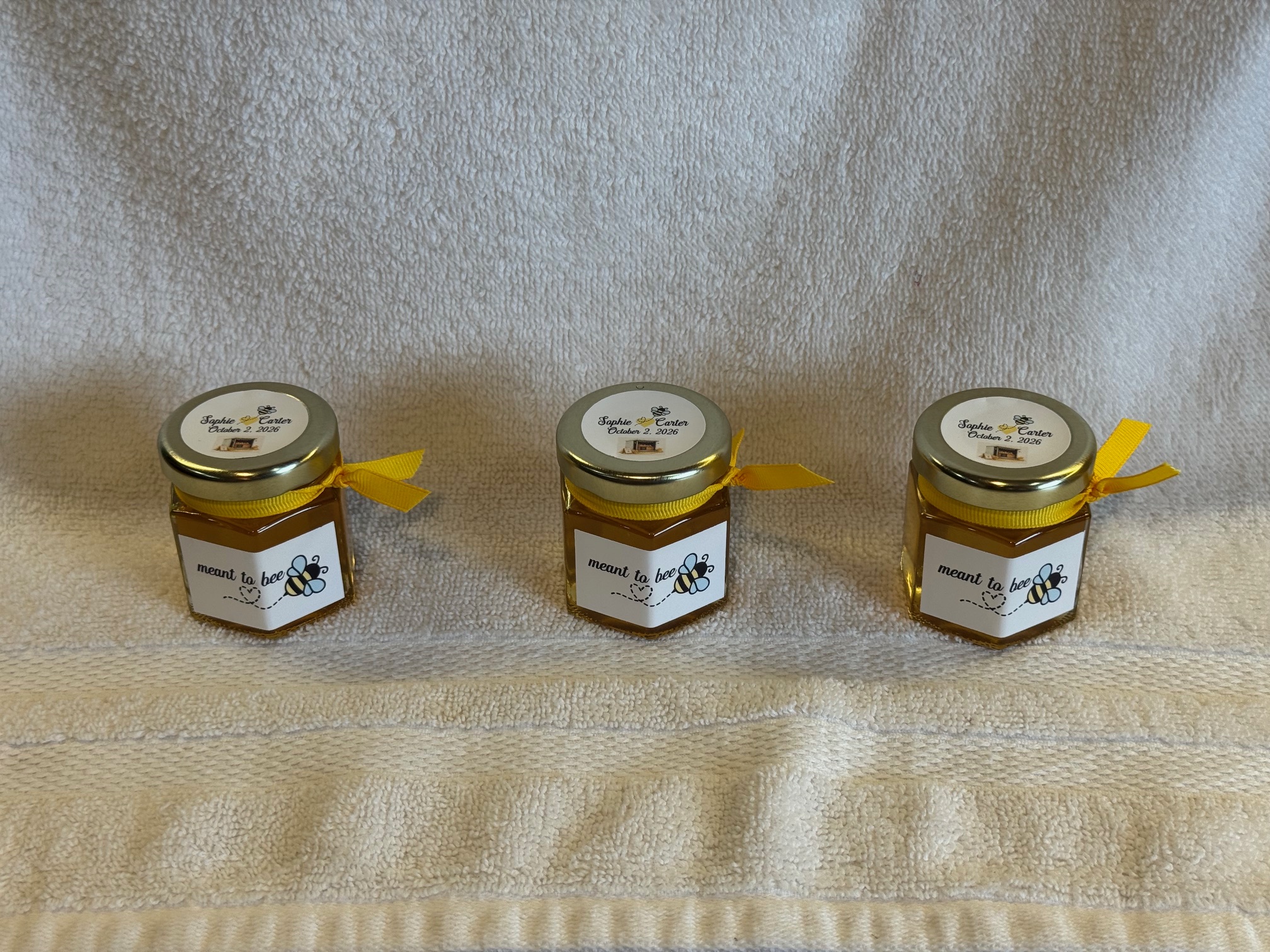 Small honey jar wedding favors with custom labels and twine bows from The Local Honey Hive